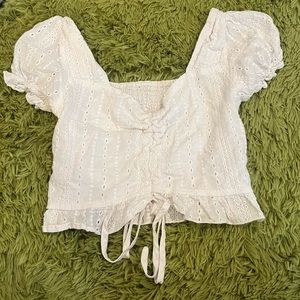 Plain white crop top, never worn, ruffled sleeves, small patterns